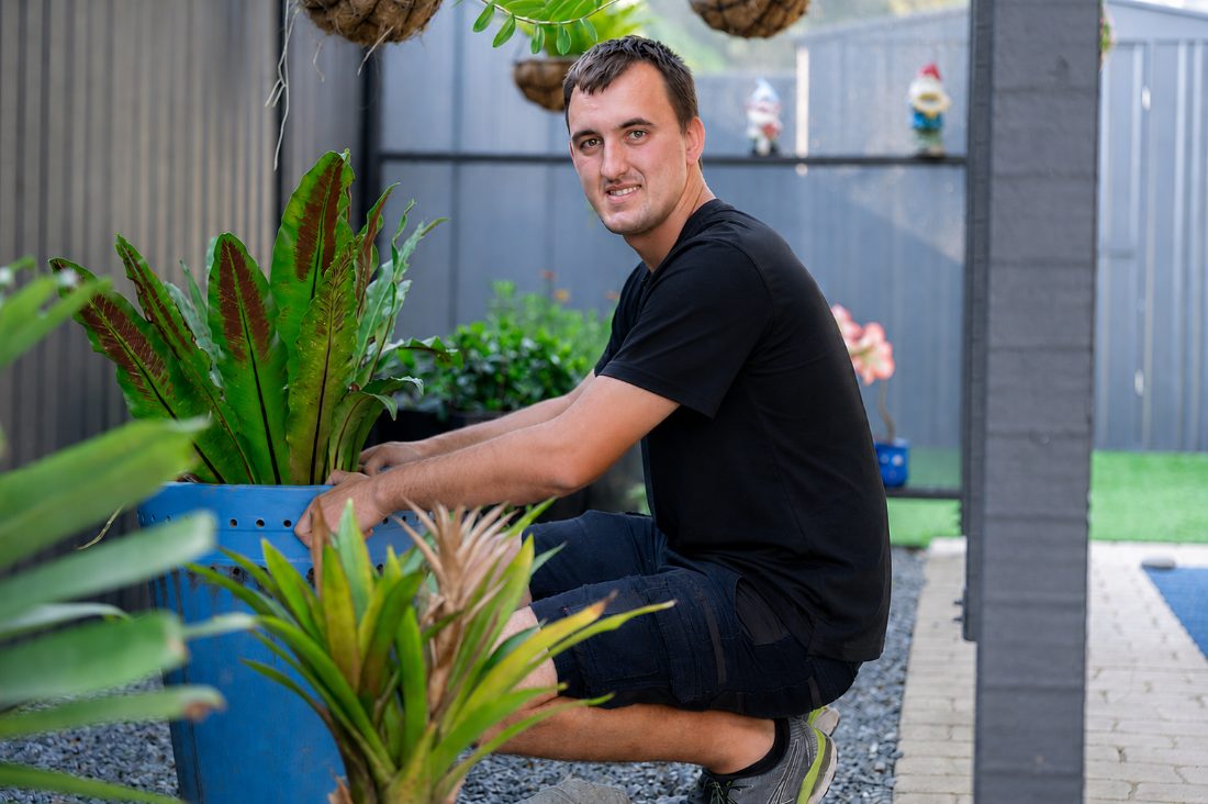 A Therapy Care worker tending a garden